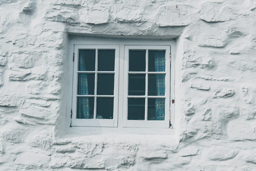 Close-up of a white wooden window frame, relevant to sealing against draughts