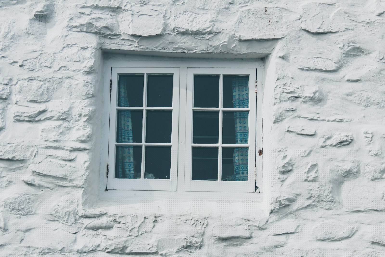 Close-up of a white wooden window frame, relevant to sealing against draughts