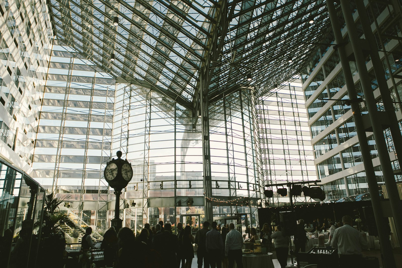 People walking inside a building during the day, with a wedding reception in the atrium